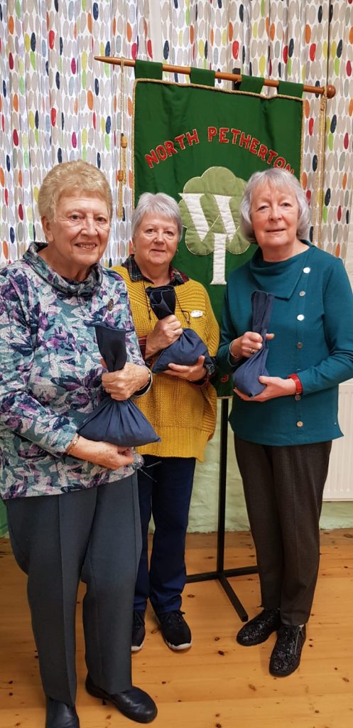 North Petherton Wi presenting Carole Summerfield with £210, mostly in 5ps.